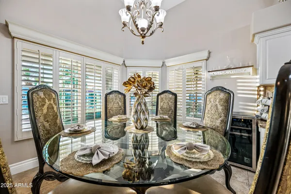 a view of a chairs and table in patio with a lake view