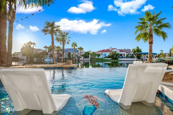 a view of a roof deck with couches and sky view