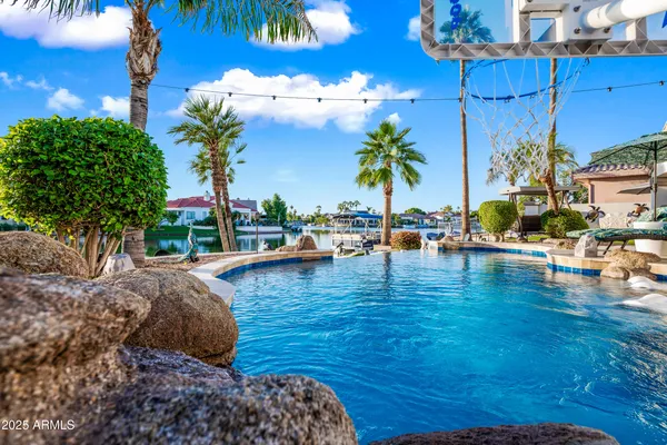 a view of a house with swimming pool and sitting area