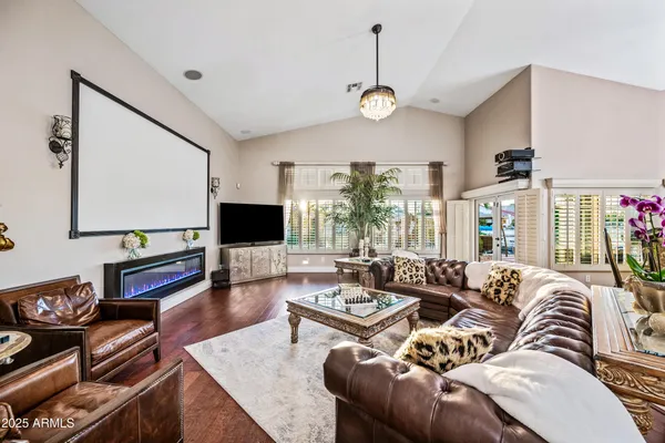 a living room with furniture a rug and a flat screen tv