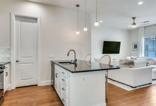 a kitchen with stainless steel appliances granite countertop a sink and a microwave