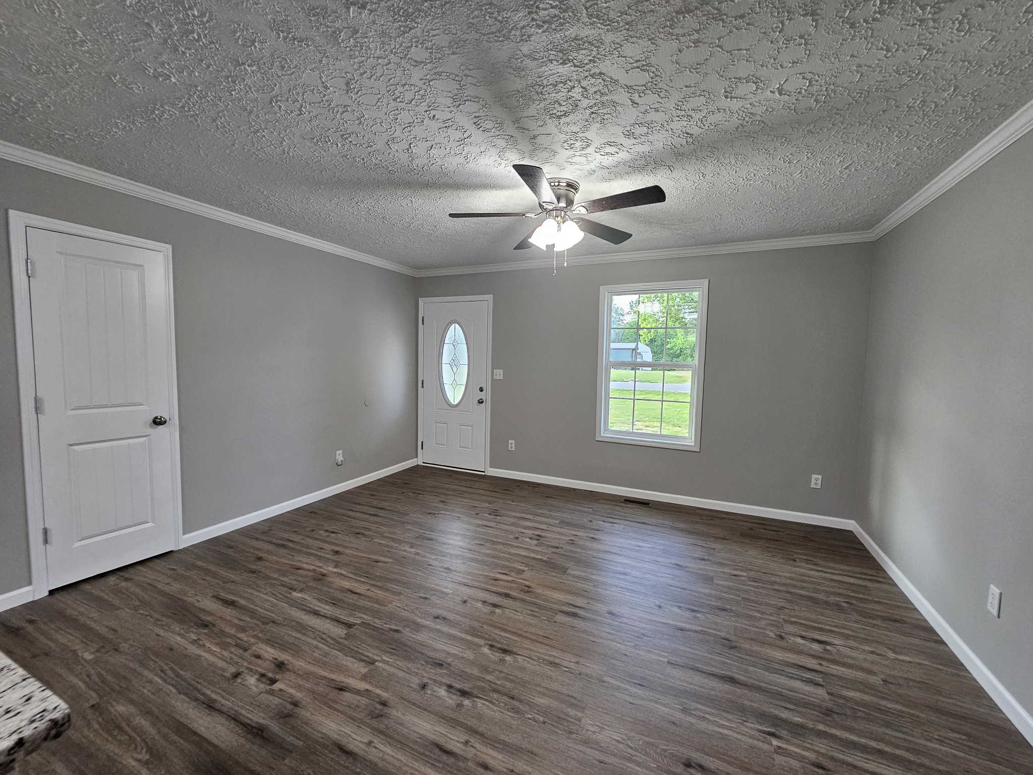 362 Forest Point Road Monteagle, TN 37356 - Photo 23 of 42 an empty room with wooden floor chandelier fan and windows