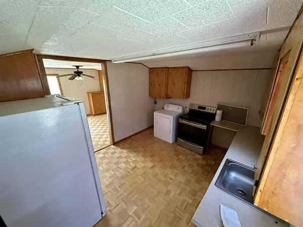 a kitchen with refrigerator and window