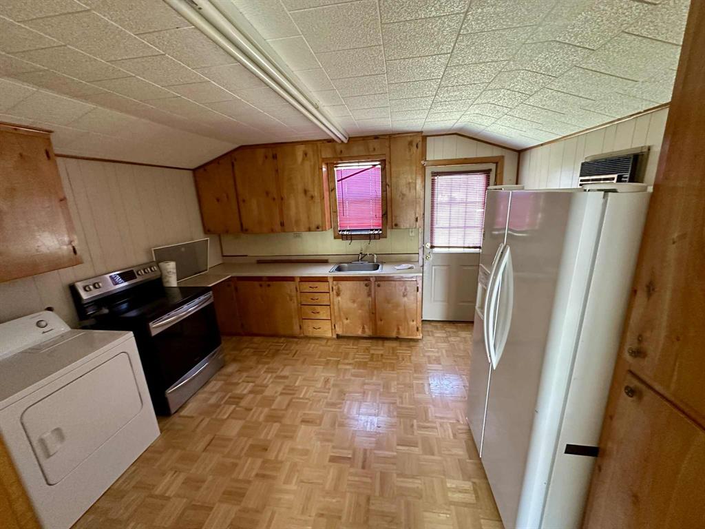 366 St Kitts Road Comanche, TX 76442 - Photo 15 of 20 a kitchen with refrigerator and window