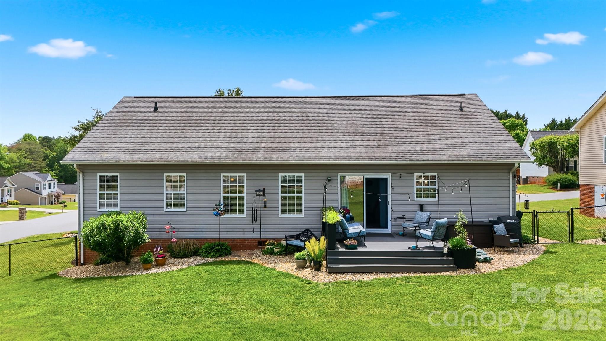 2104 Sheffield Court Northwest Conover, NC 28613 - Photo 21 of 25 a view of a house with a yard potted plants and a table