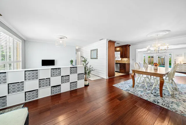 a view of a dining room with furniture wooden floor and chandelier