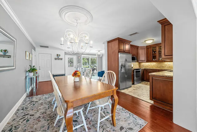 a kitchen with stainless steel appliances granite countertop a sink and wooden cabinets