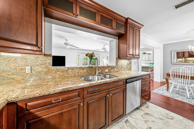 a kitchen with stainless steel appliances granite countertop a stove a sink and a refrigerator
