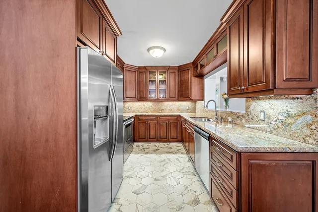 a kitchen with stainless steel appliances granite countertop a stove microwave and refrigerator