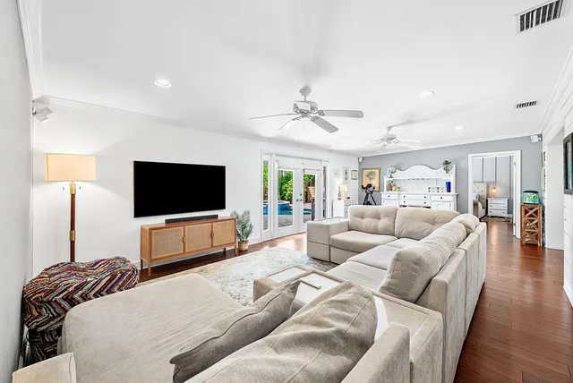a bedroom with bed and wooden floor
