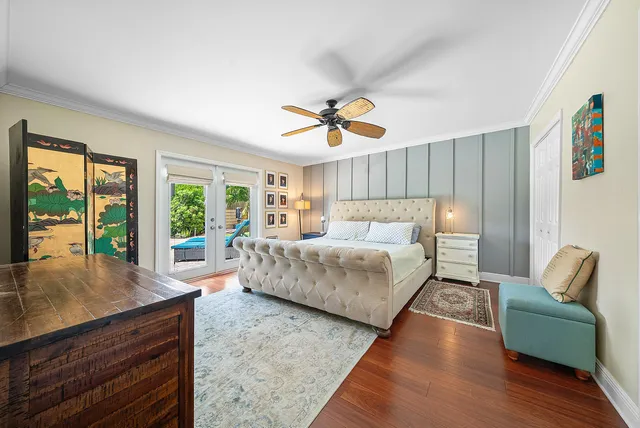a living room with furniture a flat screen tv and a floor to ceiling window
