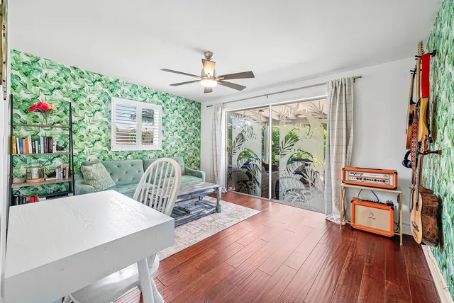 a living room with furniture and a baby crib