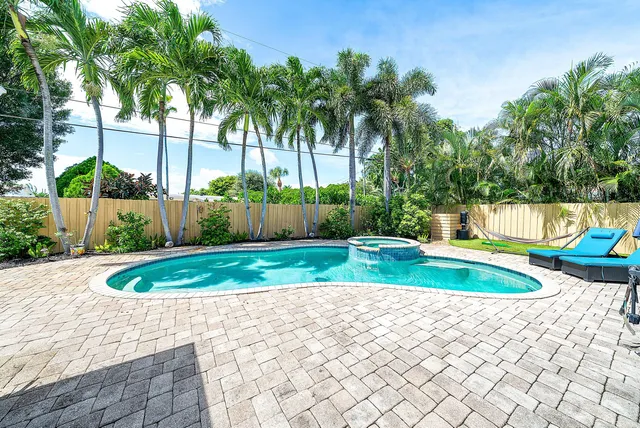 a view of a patio with a dining table and chairs