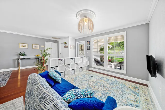 a living room with furniture and view of kitchen