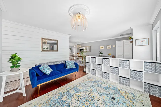 a living room with furniture and wooden floor