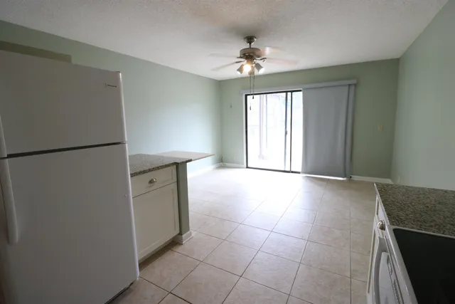 a view of a kitchen with a sink dishwasher and a refrigerator