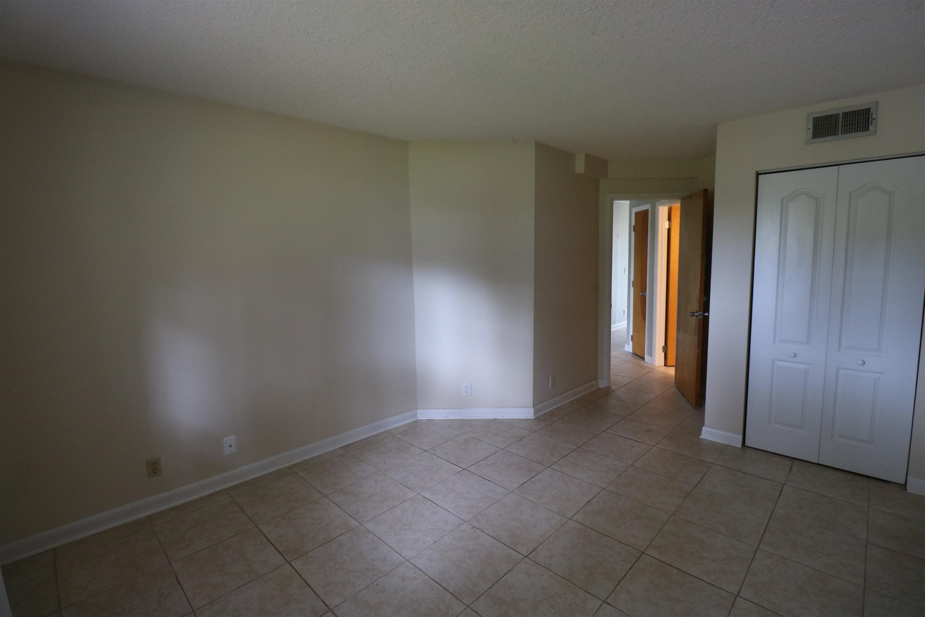1255 Ponce Island Drive, Unit 739 St. Augustine, FL 32095 - Photo 4 of 10 an empty room with closet and windows