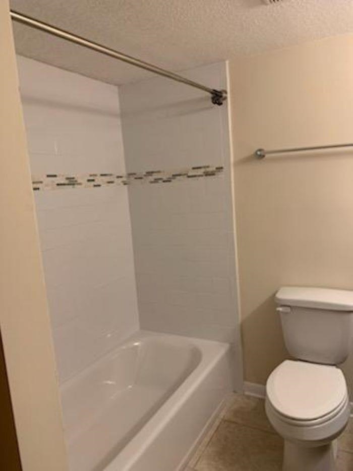 1255 Ponce Island Drive, Unit 739 St. Augustine, FL 32095 - Photo 6 of 10 a white toilet sitting next to a bath tub