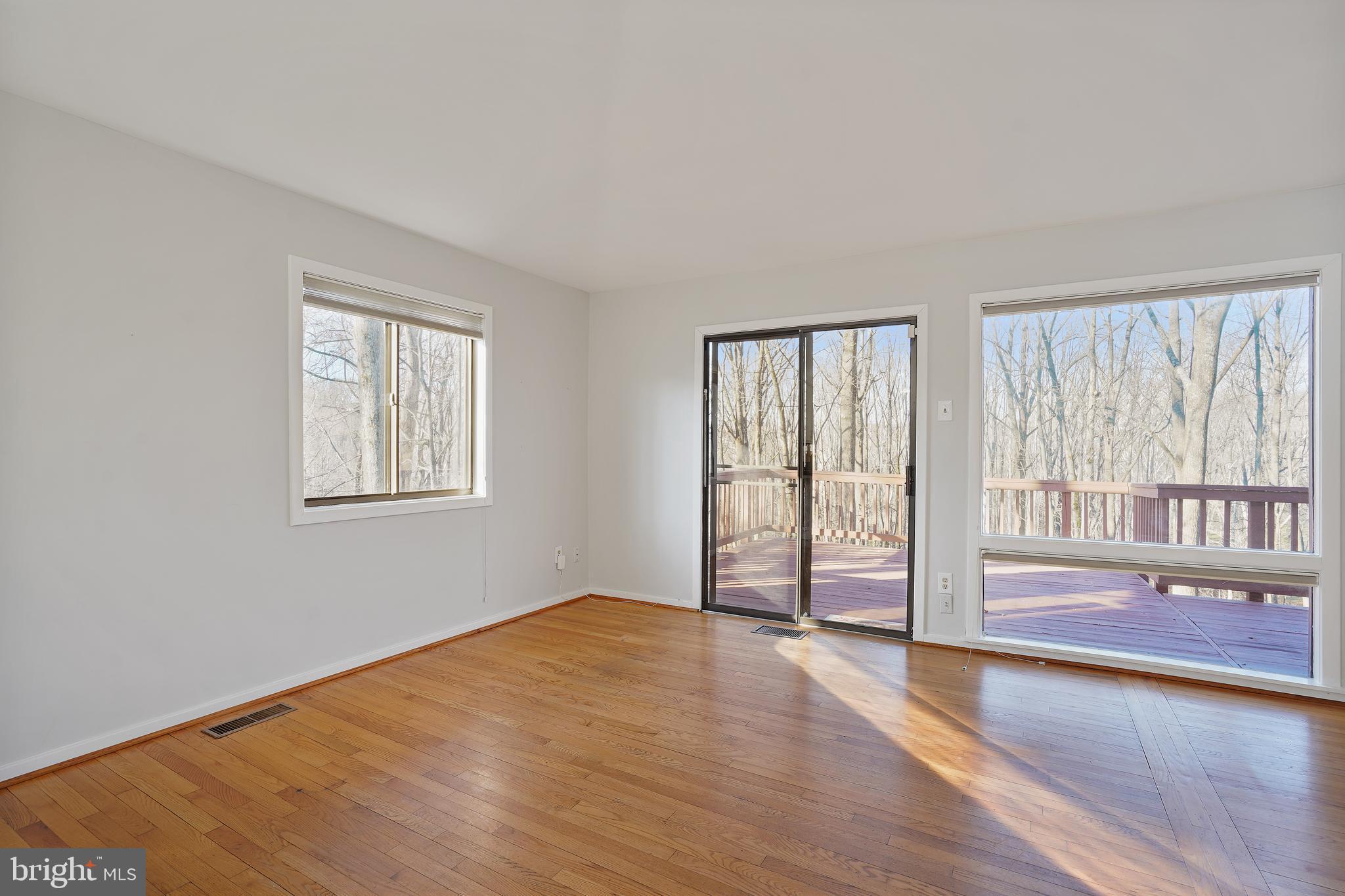 1052 Bellview Road McLean, VA 22102 - Photo 11 of 36 a view of an empty room with wooden floor and a window