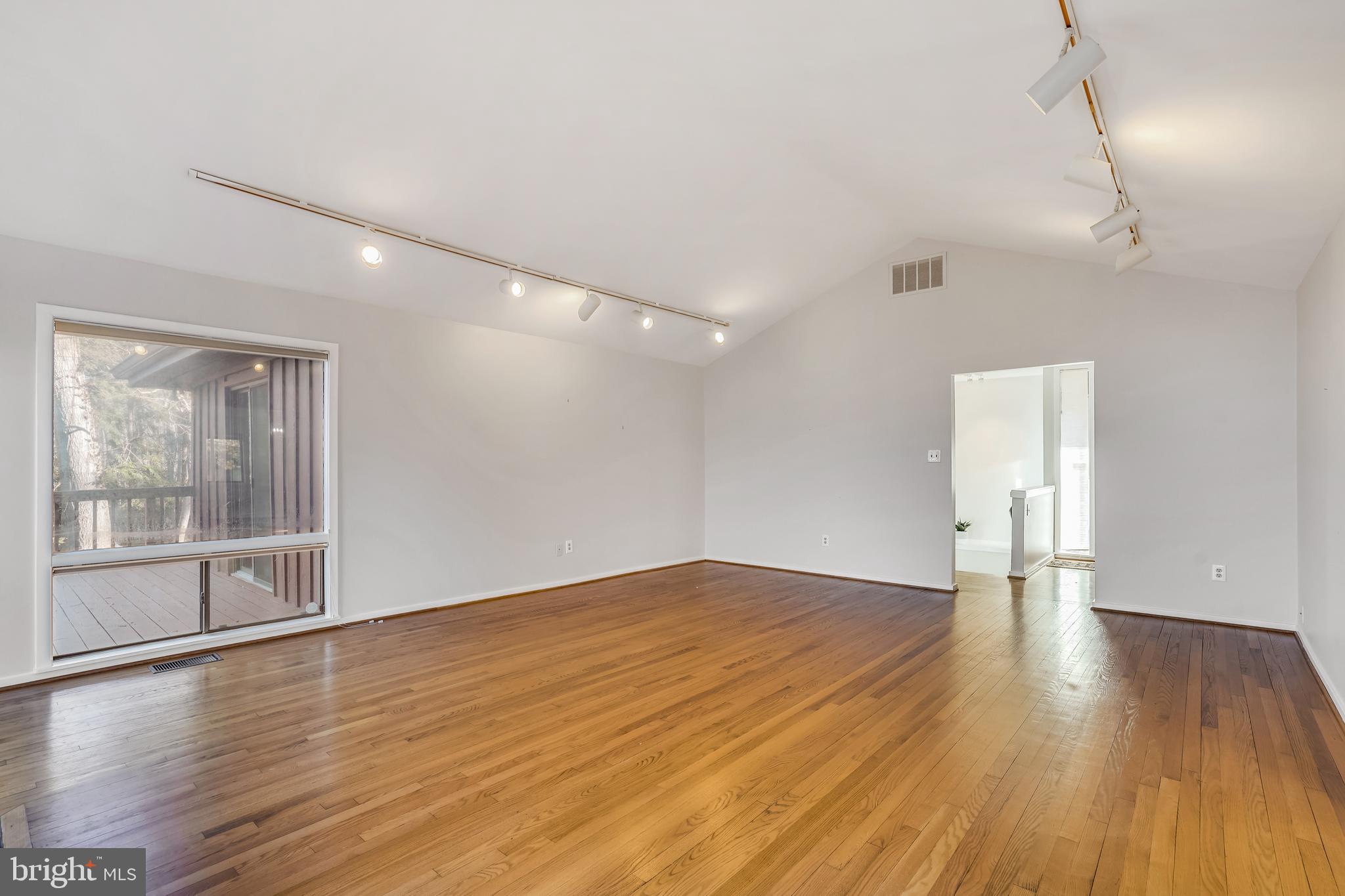 1052 Bellview Road McLean, VA 22102 - Photo 12 of 36 a view of an empty room with wooden floor and a window