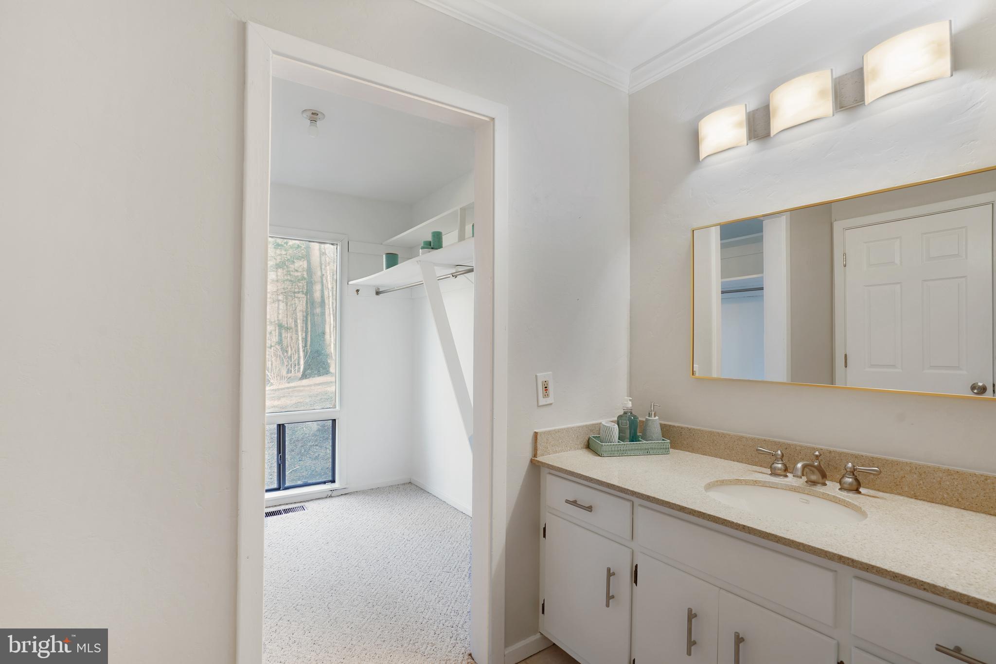 1052 Bellview Road McLean, VA 22102 - Photo 17 of 36 a bathroom with a granite countertop sink and a mirror