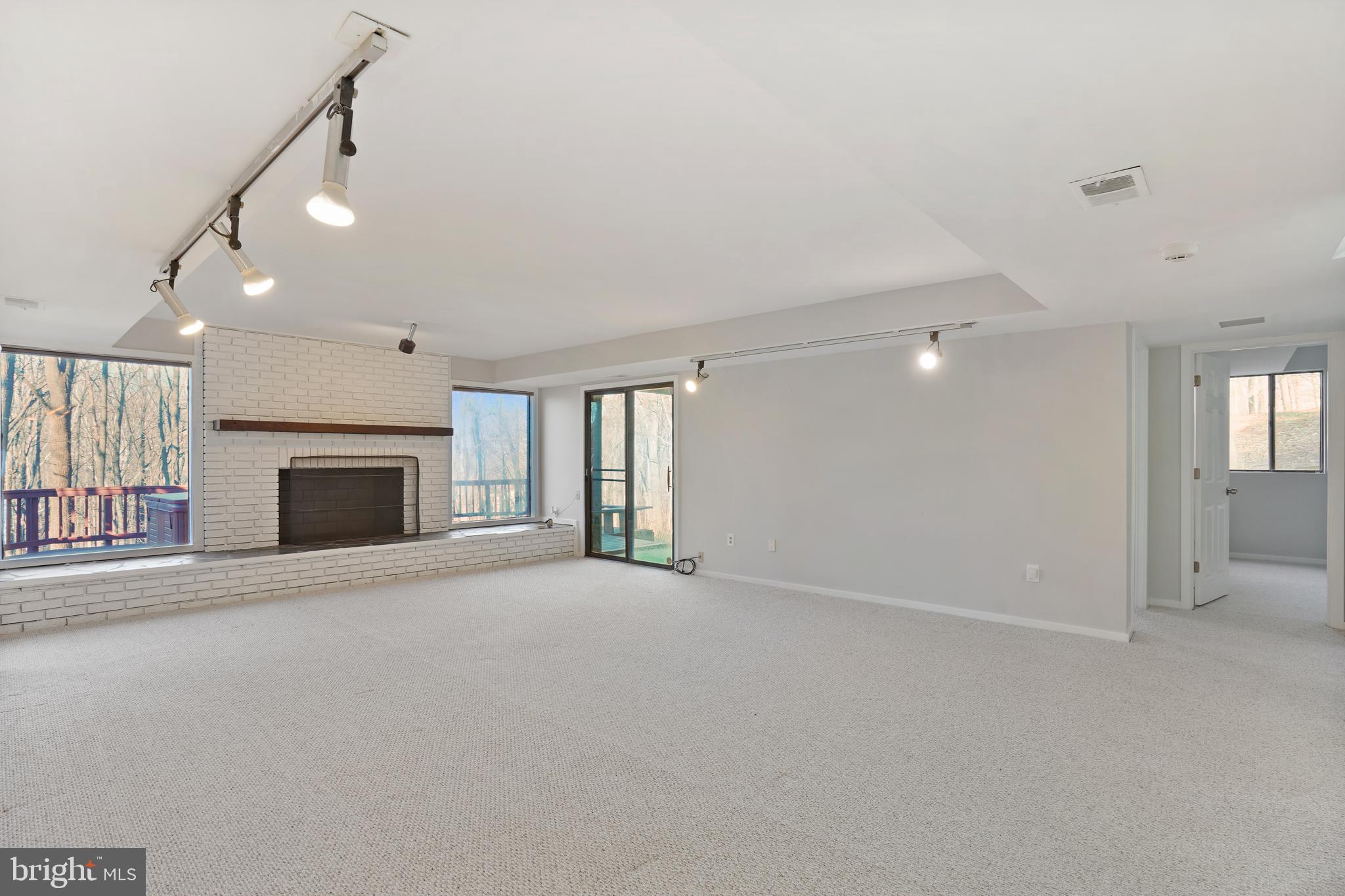 1052 Bellview Road McLean, VA 22102 - Photo 19 of 36 an empty room with fireplace and windows