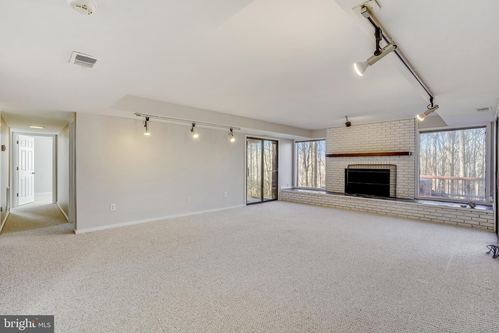 1052 Bellview Road McLean, VA 22102 - Photo 20 of 36 a view of an empty room with a fireplace and a window