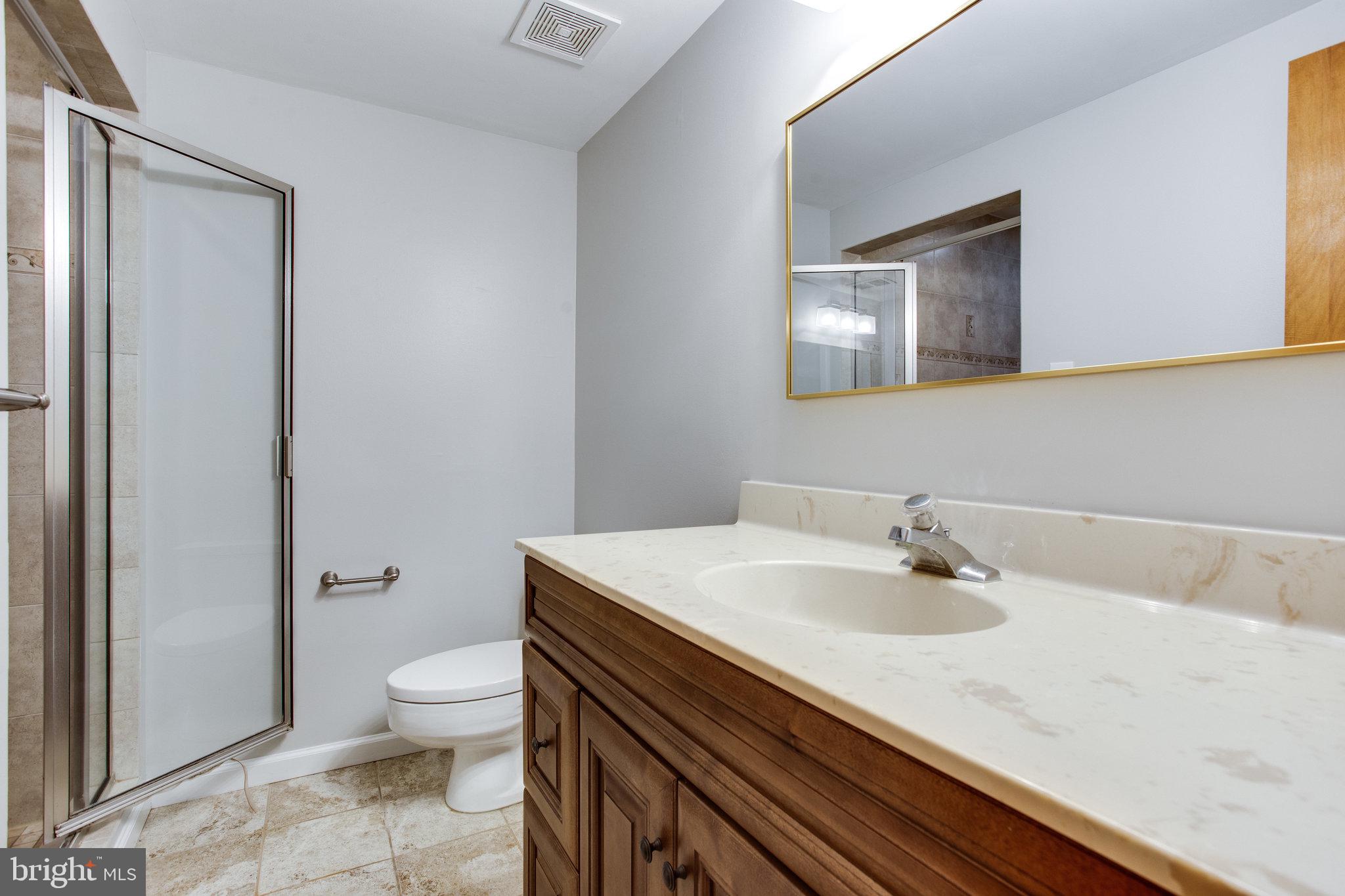 1052 Bellview Road McLean, VA 22102 - Photo 27 of 36 a bathroom with a sink a toilet and shower