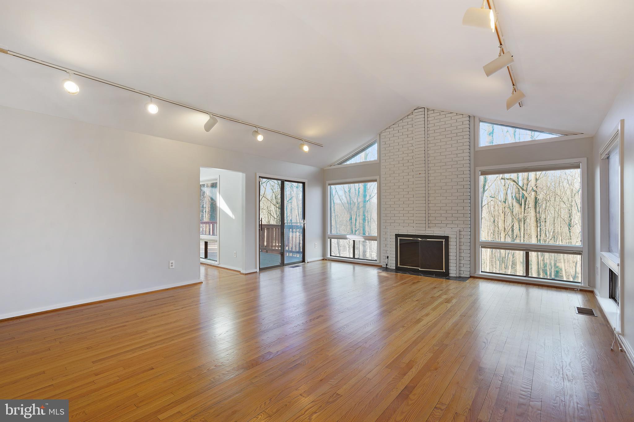 1052 Bellview Road McLean, VA 22102 - Photo 4 of 36 a view of an empty room with wooden floor and a window
