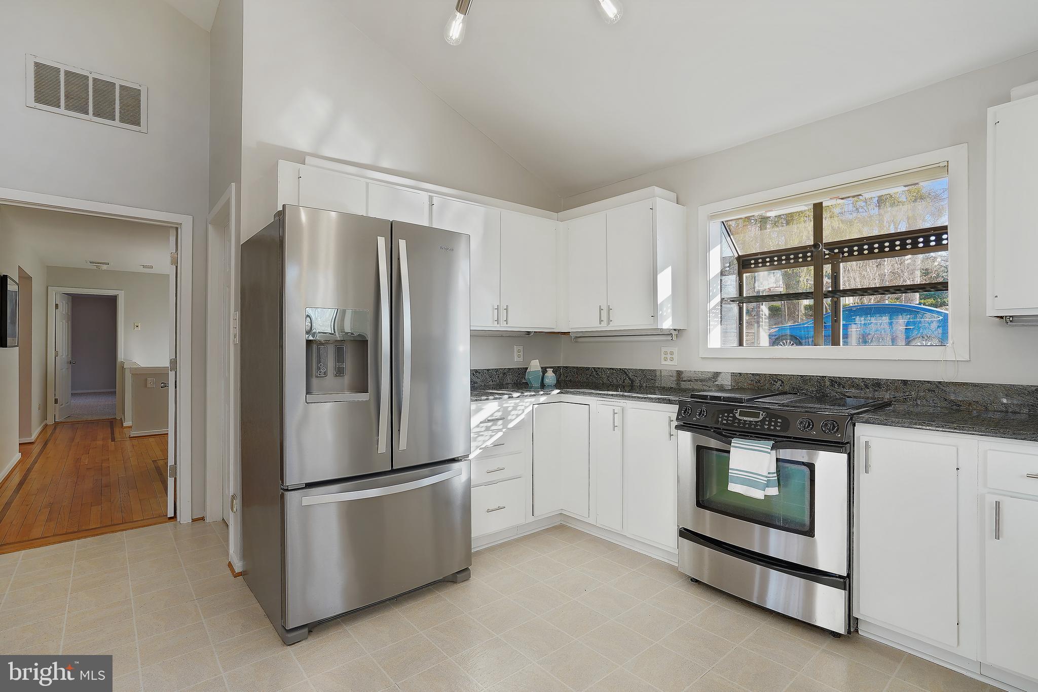 1052 Bellview Road McLean, VA 22102 - Photo 7 of 36 a kitchen with stainless steel appliances granite countertop a refrigerator and a stove top oven