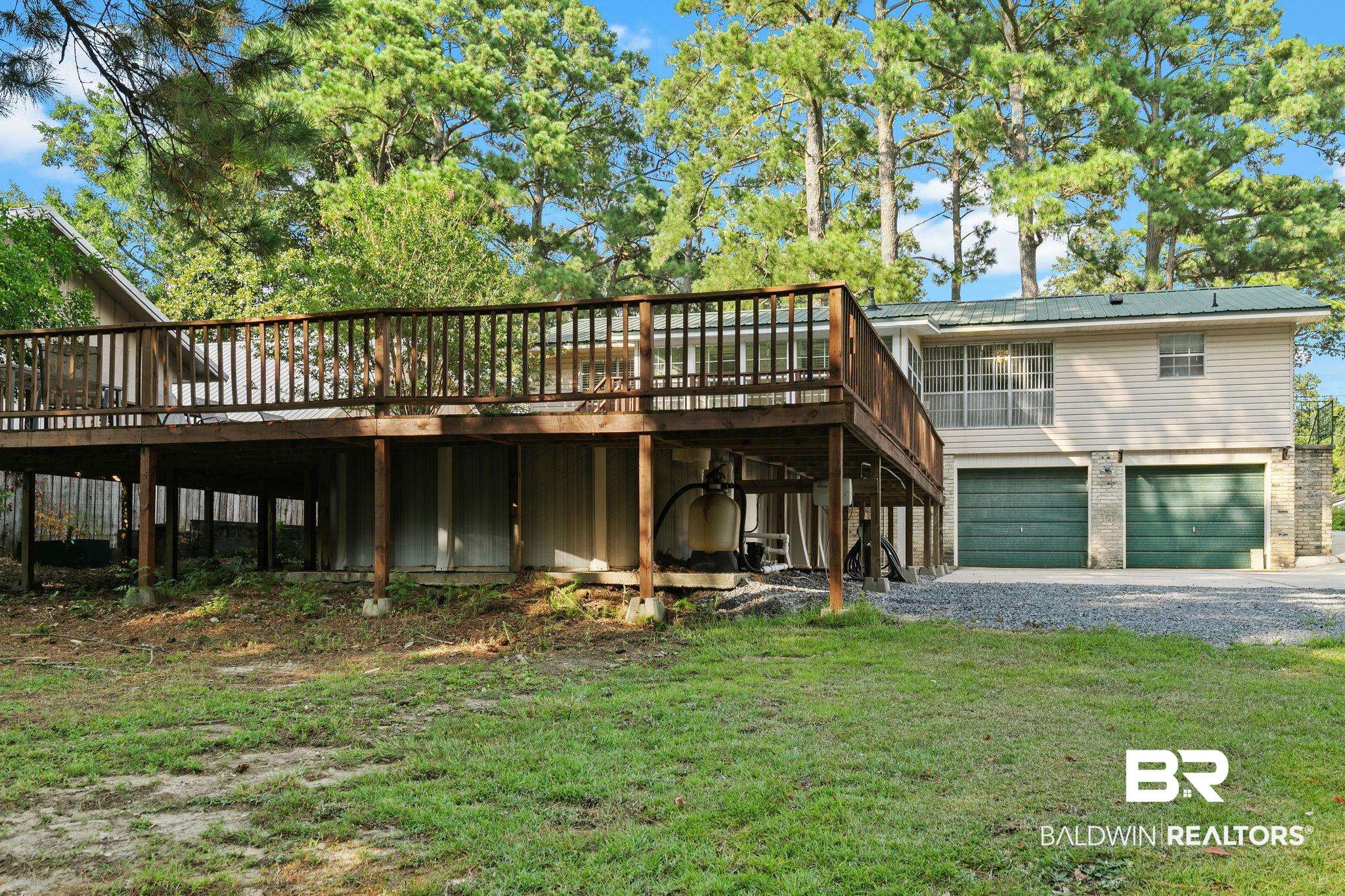 14 Lee Circle Daphne, AL 36527 - Photo 70 of 83 Rear view of house featuring a deck, a garage, and a lawn