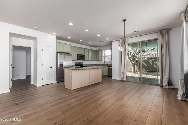 a view of a kitchen with wooden floor and a window