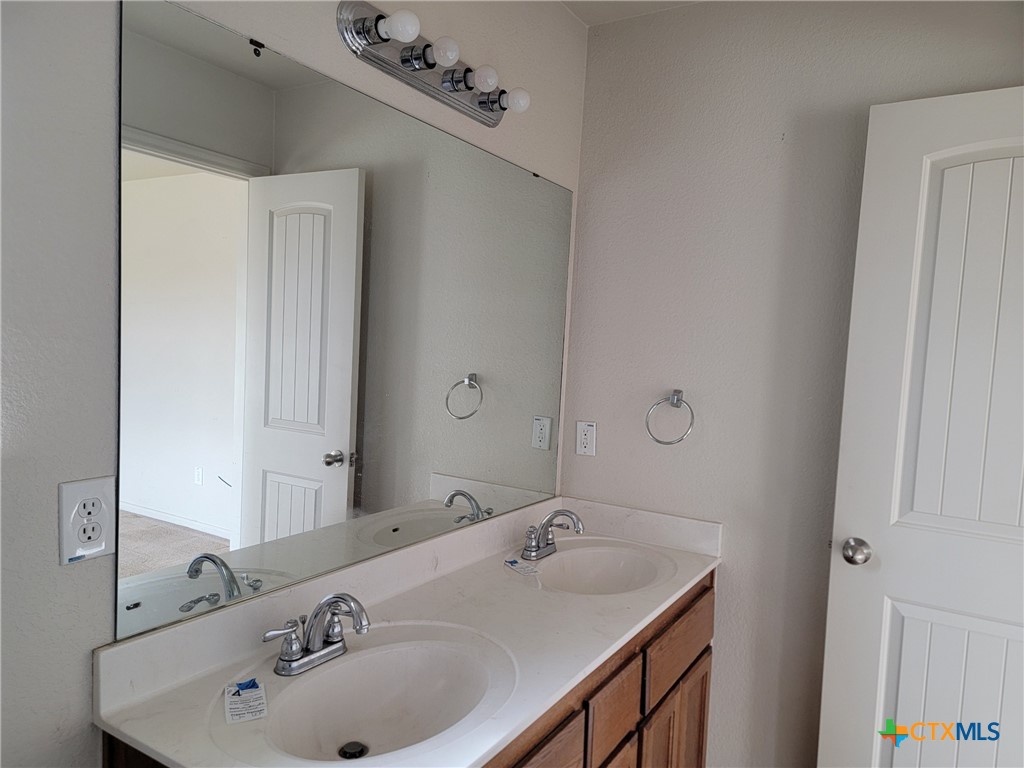 3505 Logsdon Street Copperas Cove, TX 76522 - Photo 11 of 17 a bathroom with a sink and mirror