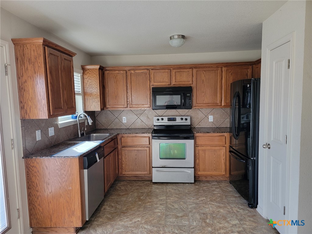 3505 Logsdon Street Copperas Cove, TX 76522 - Photo 2 of 17 a kitchen with stainless steel appliances granite countertop a refrigerator sink and stove