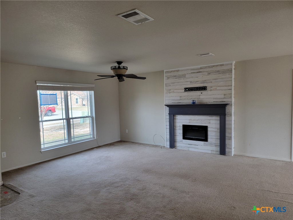 3505 Logsdon Street Copperas Cove, TX 76522 - Photo 4 of 17 an empty room with windows and fireplace