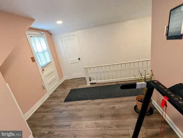 a view of an entryway with wooden floor
