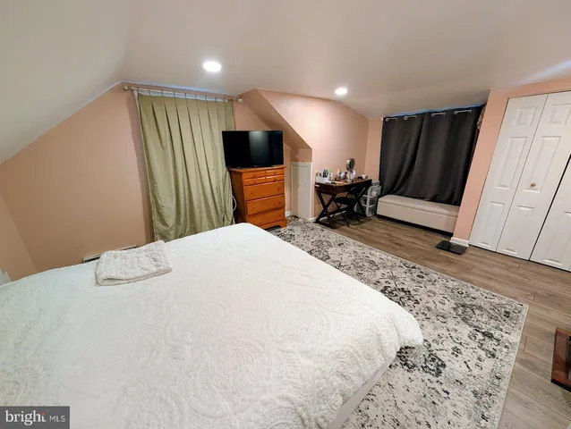 a bed room with a bed and a television