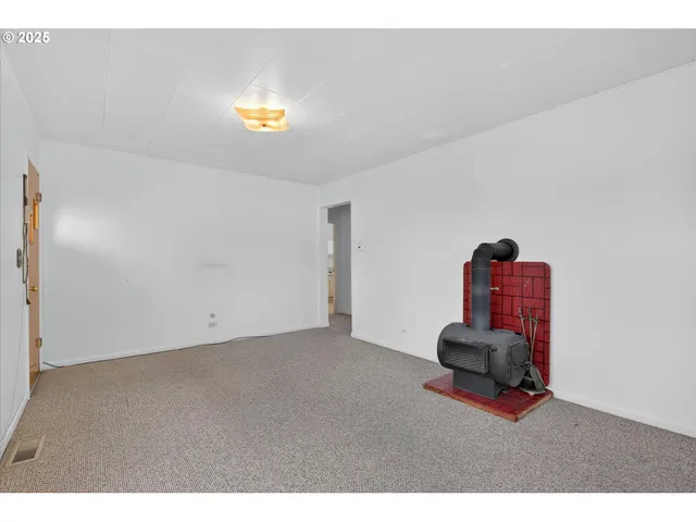 a view of furniture and chandelier in empty room