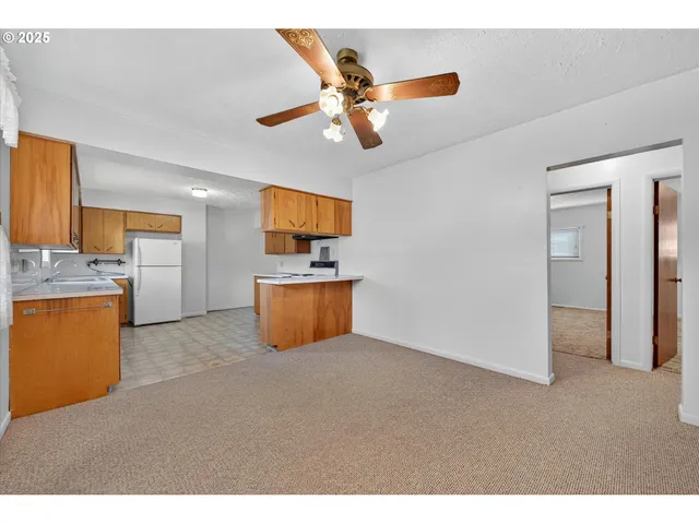 a kitchen with stainless steel appliances kitchen island a refrigerator sink and stove
