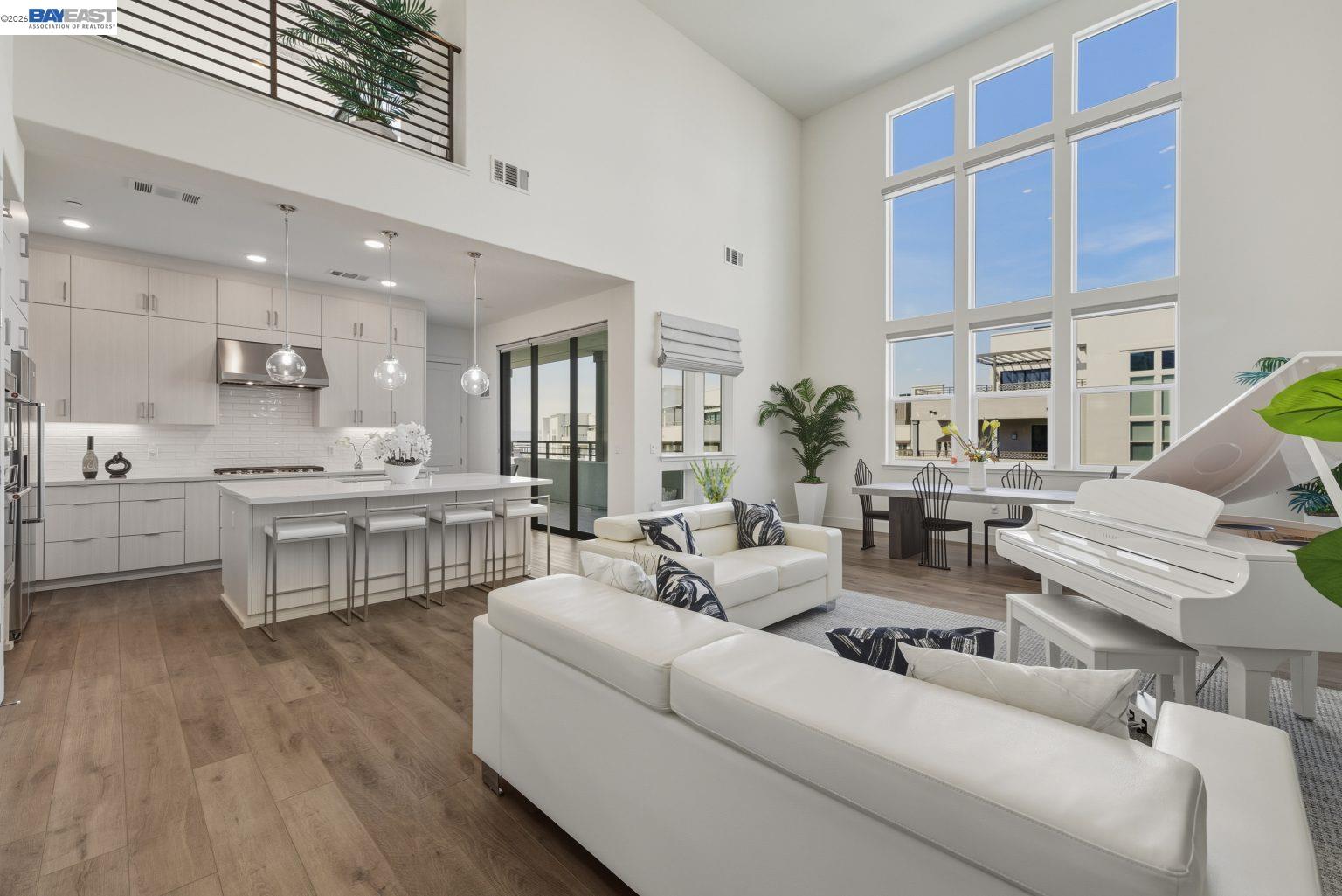 a living room with furniture white walls and kitchen view