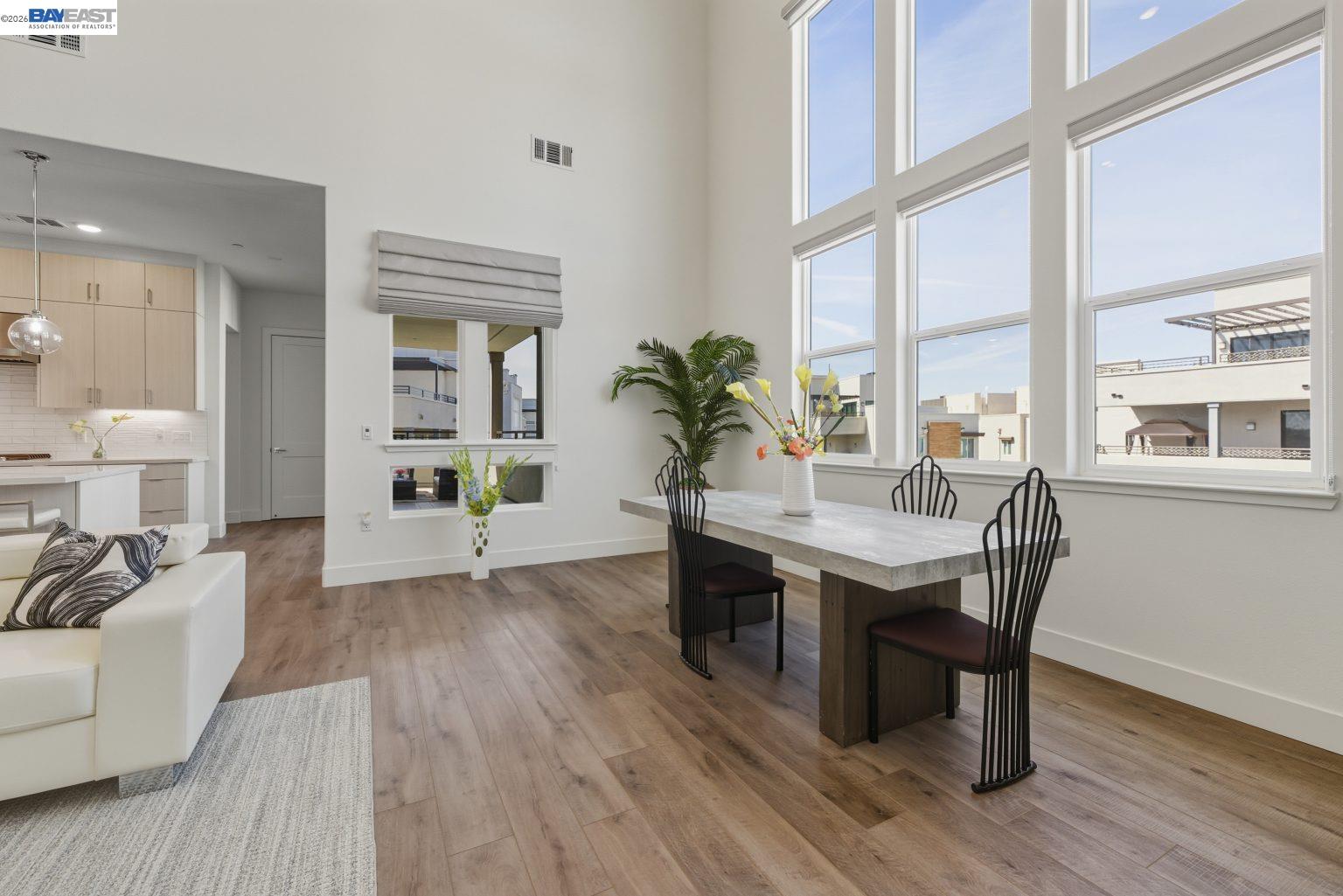 1748 Kilowatt Way, Unit 402 Fremont, CA 94539 - Photo 14 of 60 a view of a dining room with furniture window and wooden floor