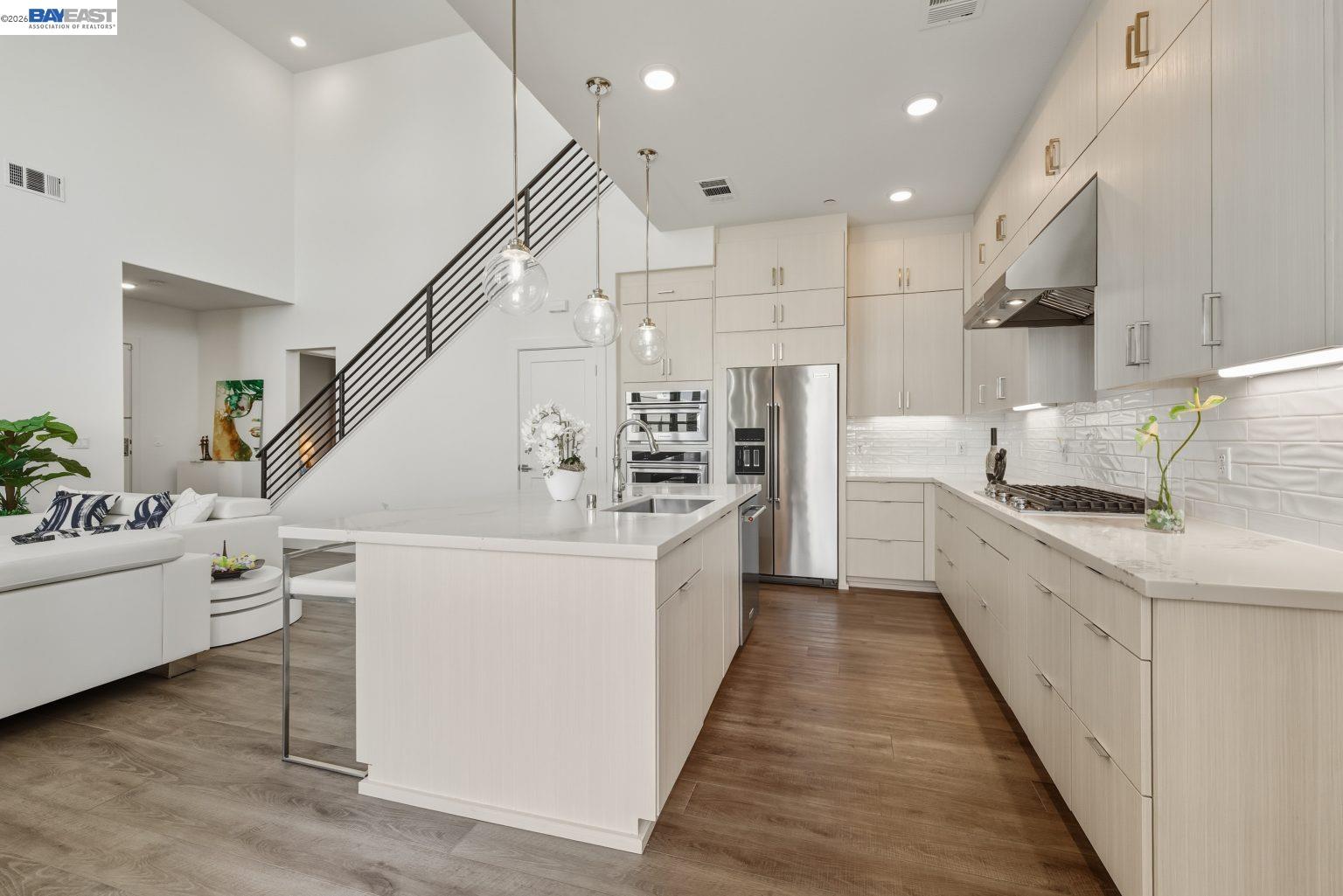 1748 Kilowatt Way, Unit 402 Fremont, CA 94539 - Photo 17 of 60 a large white kitchen with a white stove top oven and white cabinets