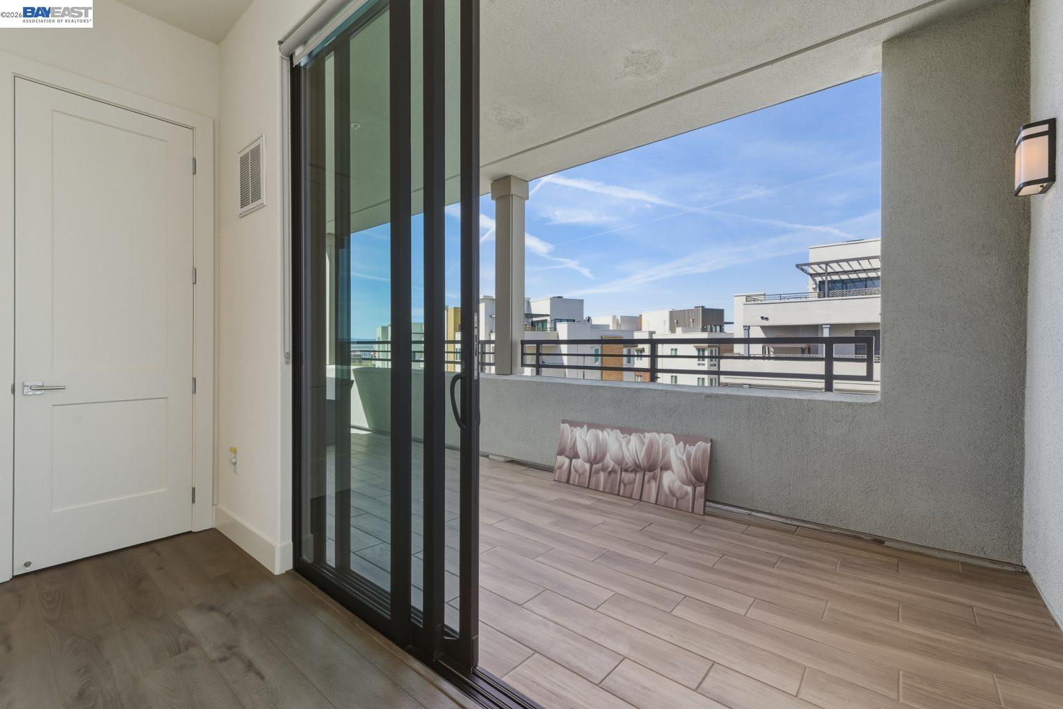 1748 Kilowatt Way, Unit 402 Fremont, CA 94539 - Photo 20 of 60 a view of a living room with a floor to ceiling window and wooden floor