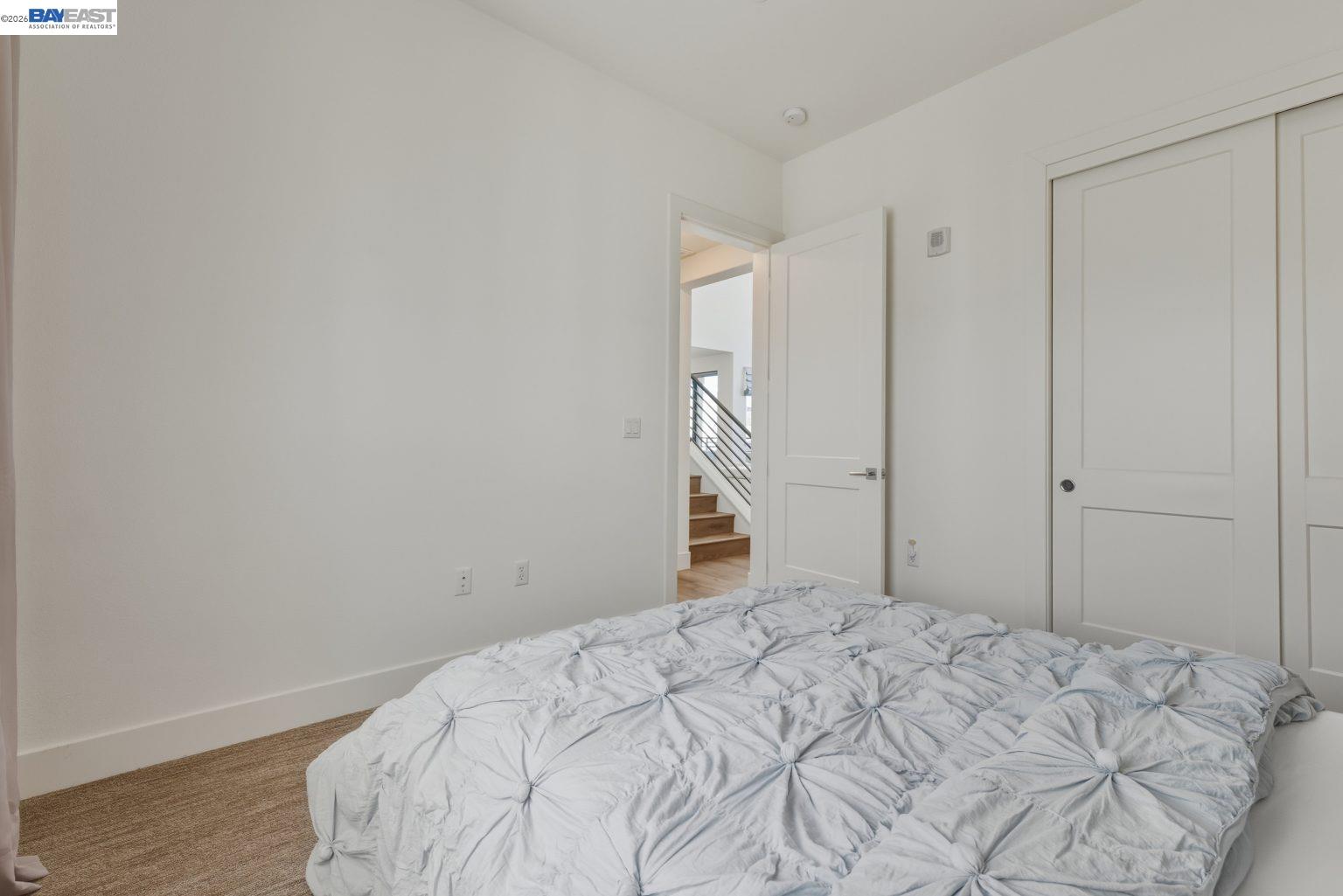 1748 Kilowatt Way, Unit 402 Fremont, CA 94539 - Photo 26 of 60 a bedroom with a bed and a rug