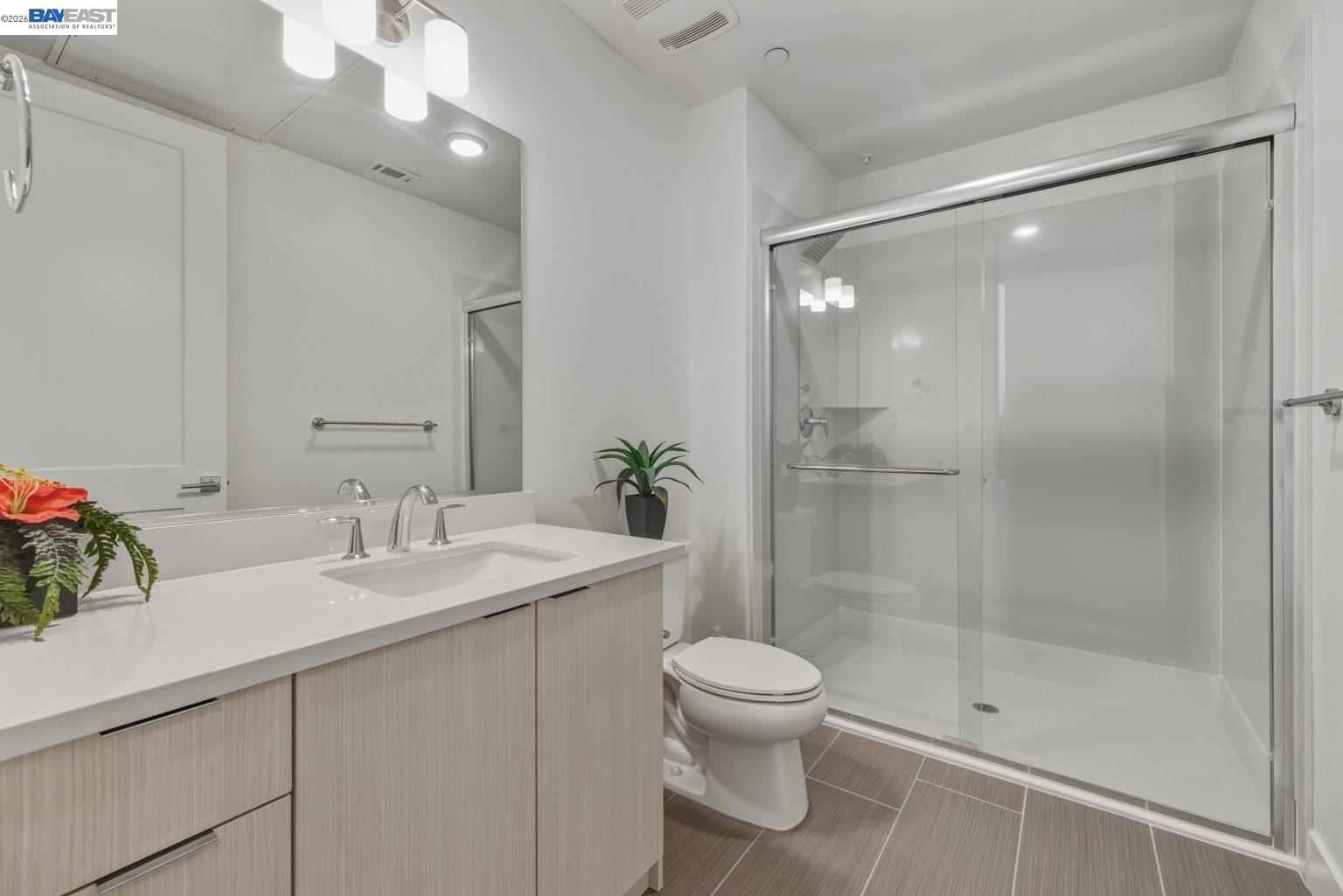 1748 Kilowatt Way, Unit 402 Fremont, CA 94539 - Photo 29 of 60 a bathroom with a sink a toilet and shower