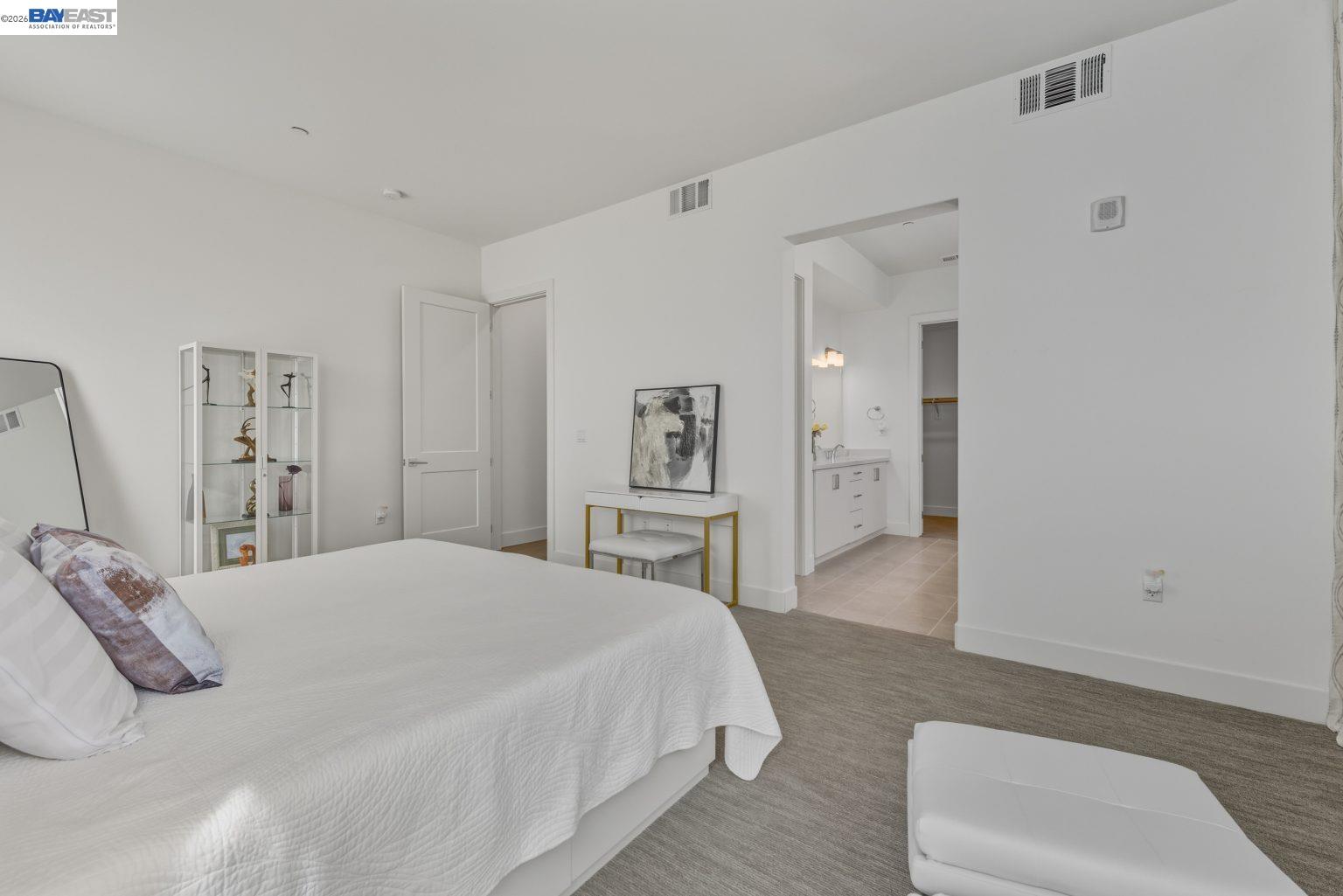 1748 Kilowatt Way, Unit 402 Fremont, CA 94539 - Photo 34 of 60 a spacious bedroom with a bed and a couch
