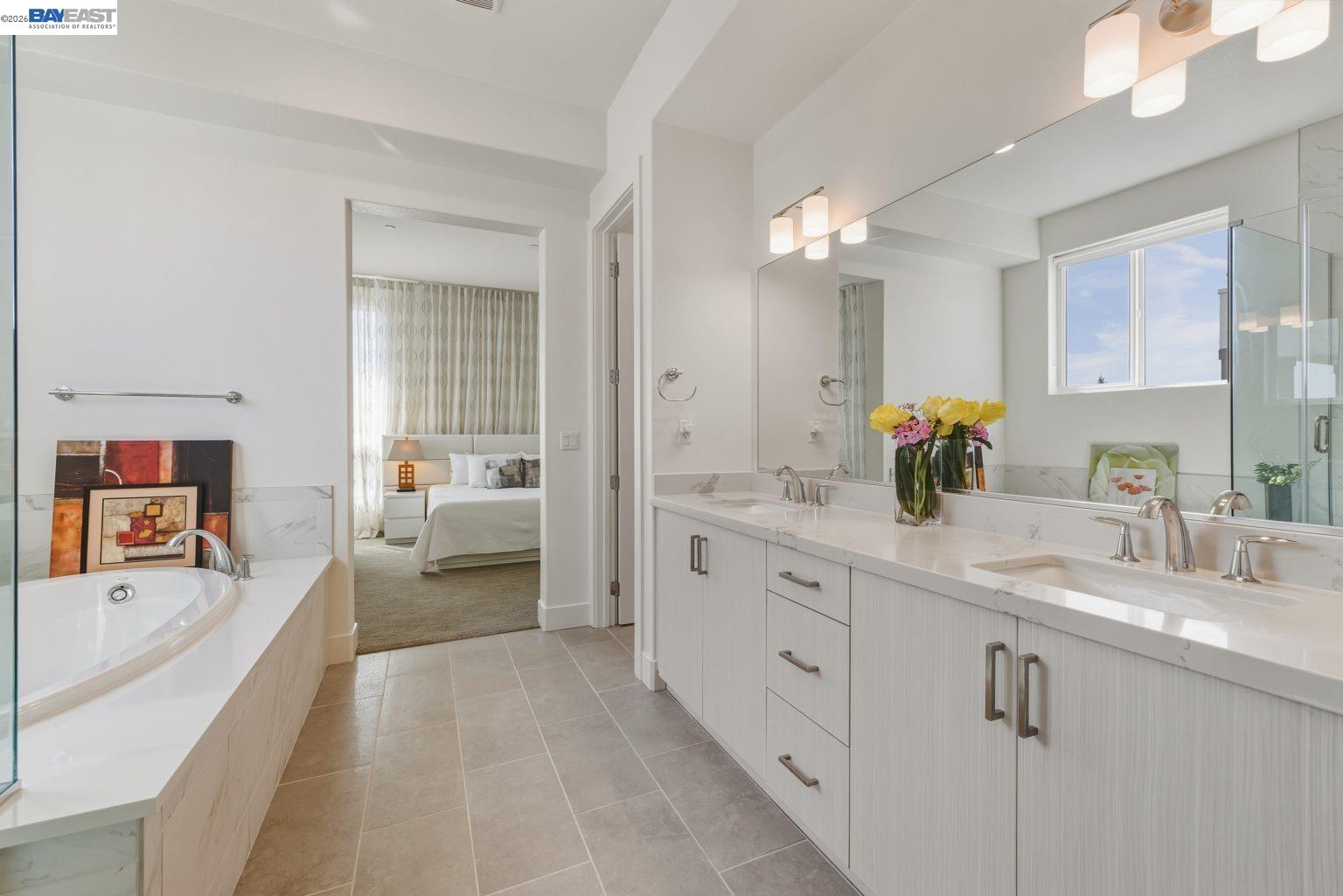1748 Kilowatt Way, Unit 402 Fremont, CA 94539 - Photo 36 of 60 a spacious en suite bathroom with a double vanity sink tub and mirror