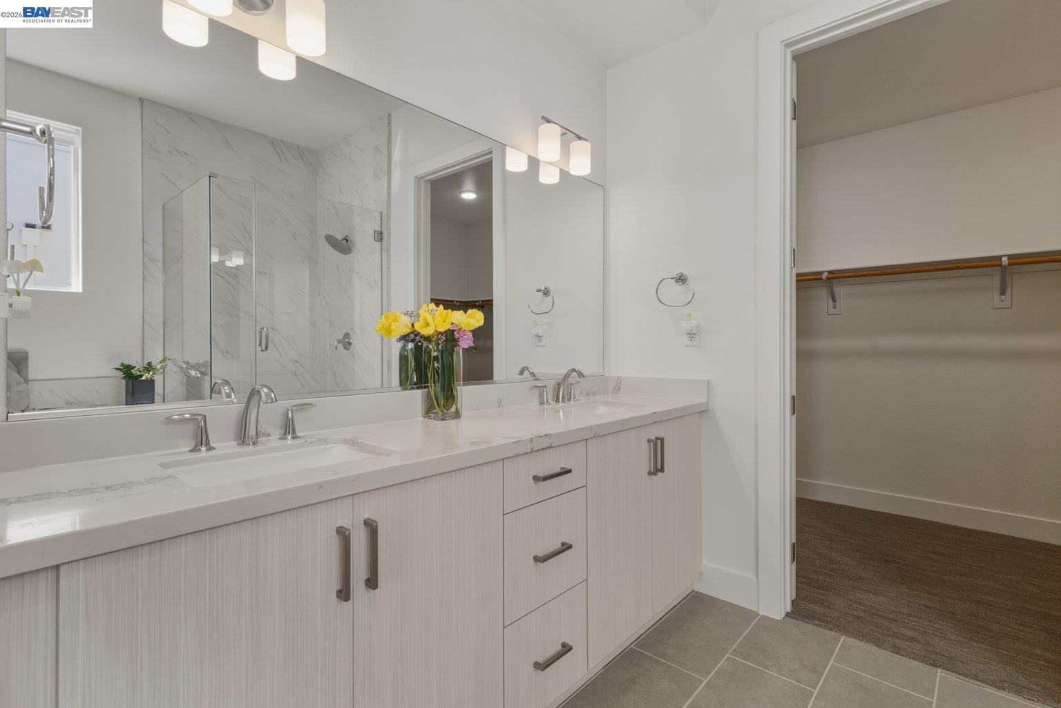 1748 Kilowatt Way, Unit 402 Fremont, CA 94539 - Photo 38 of 60 a bathroom with a double vanity sink and mirror