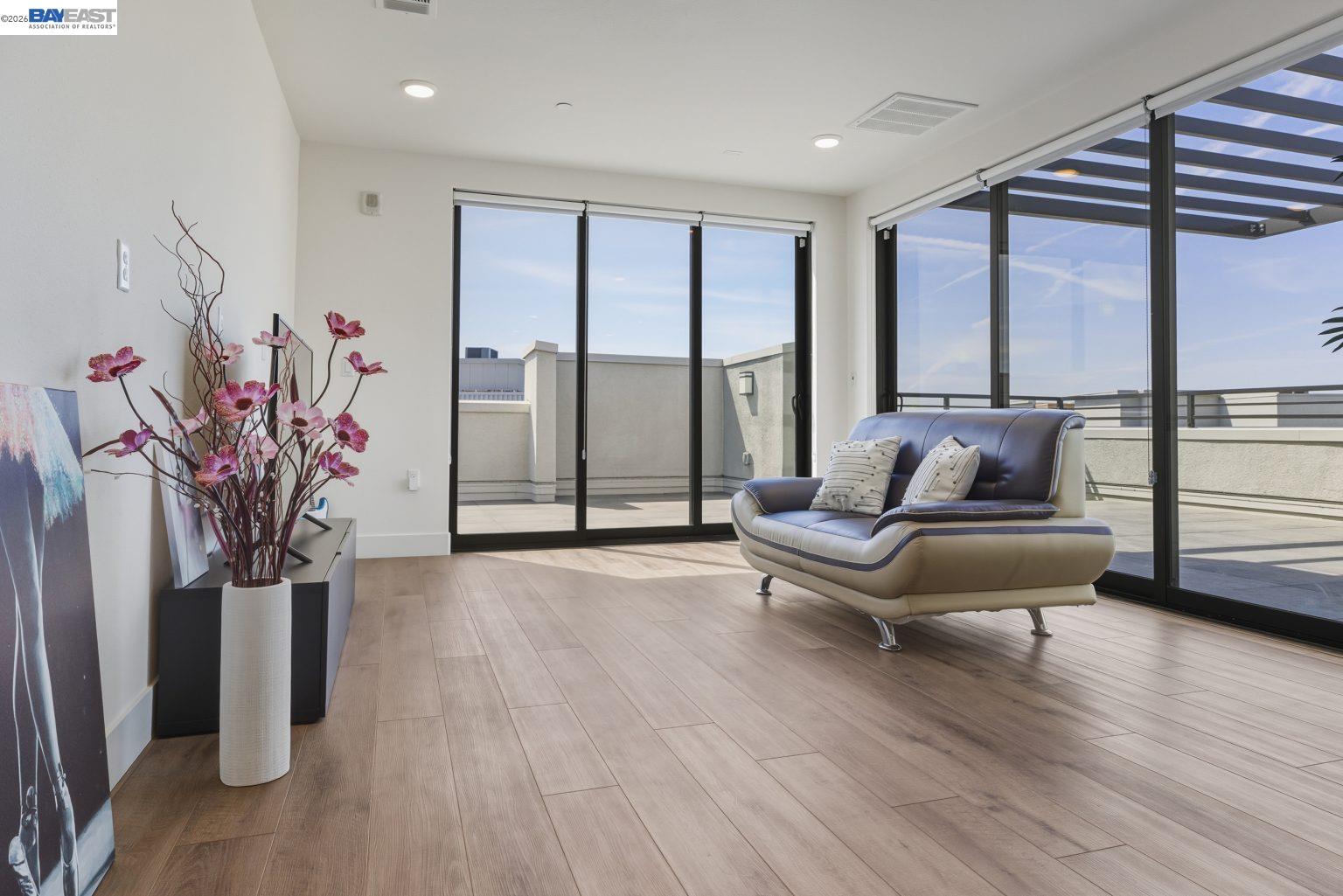 1748 Kilowatt Way, Unit 402 Fremont, CA 94539 - Photo 41 of 60 a living room with furniture and a large window with wooden floor