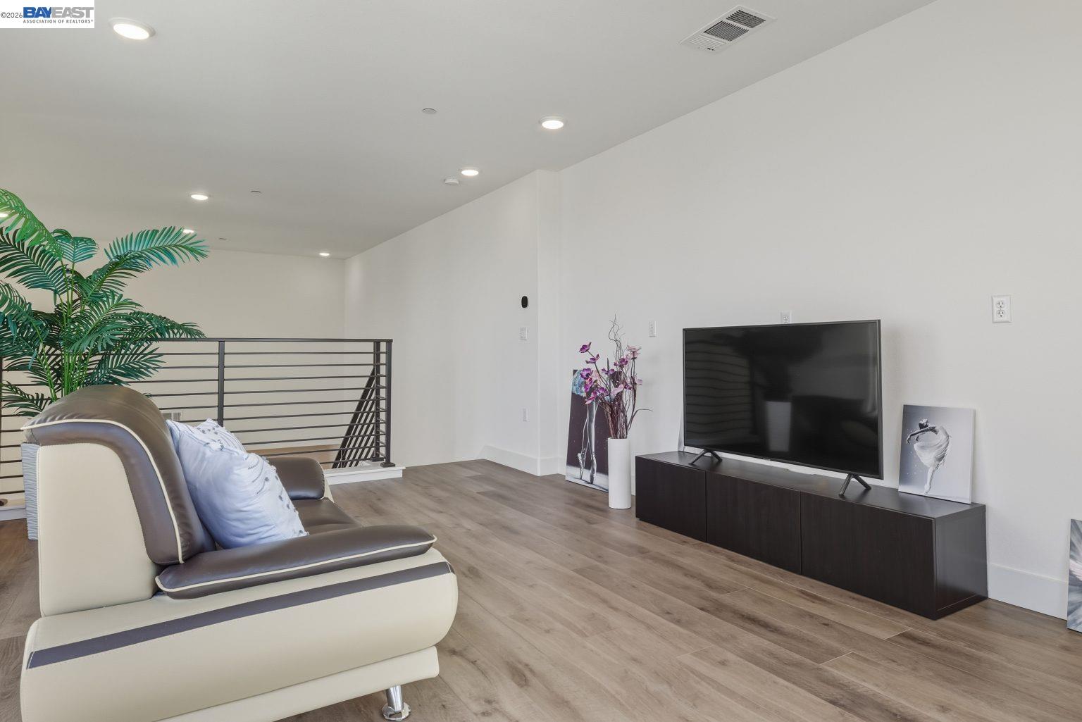 1748 Kilowatt Way, Unit 402 Fremont, CA 94539 - Photo 43 of 60 a living room with furniture and a flat screen tv